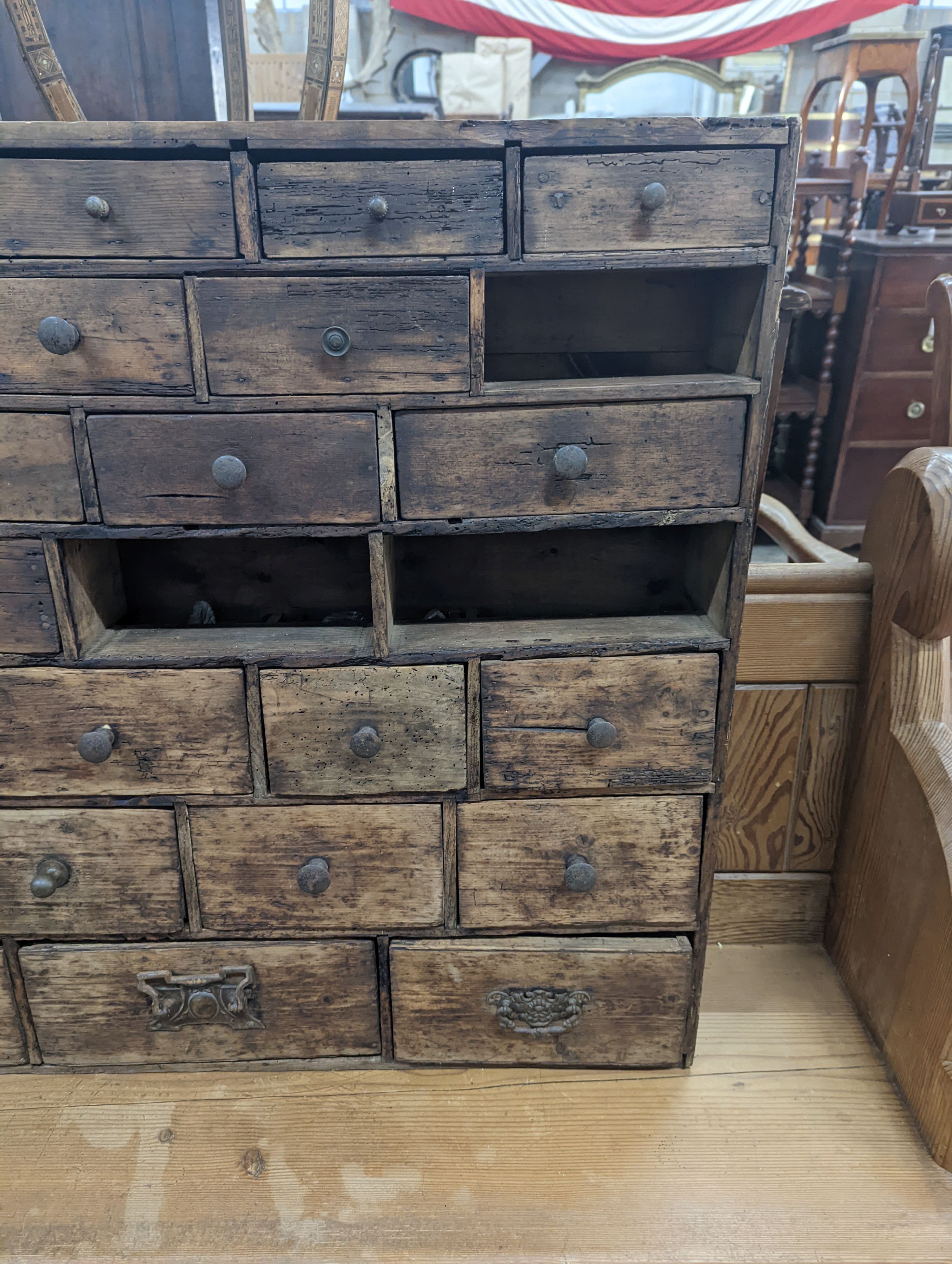 A 19th century fruitwood apothecary chest from the estate of Mary Wondrausch, containing rock samples and archaeological finds. width 91cm, depth 13cm, height 80cm (lacks three drawers)